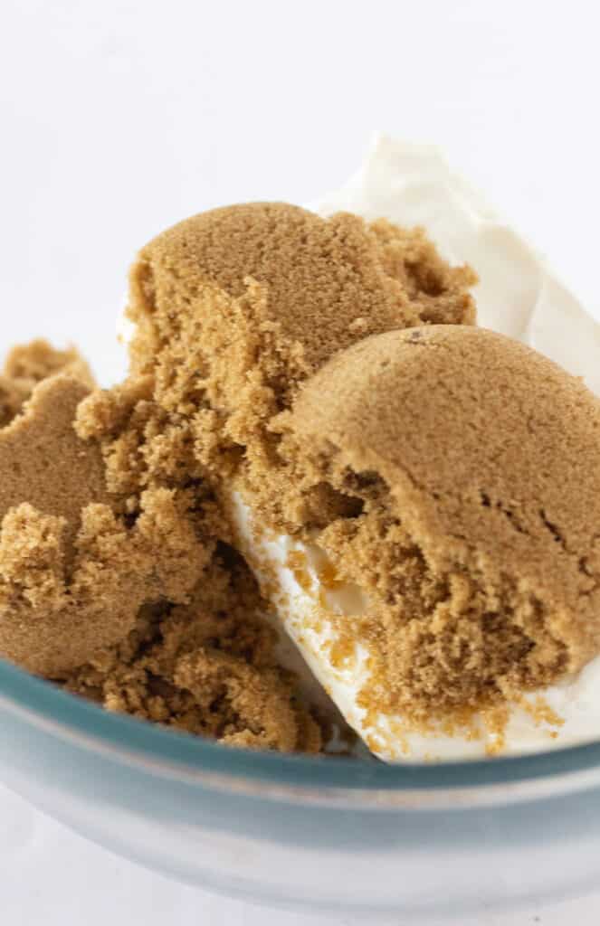 A mixing bowl of brown sugar, cream cheese, and honey.