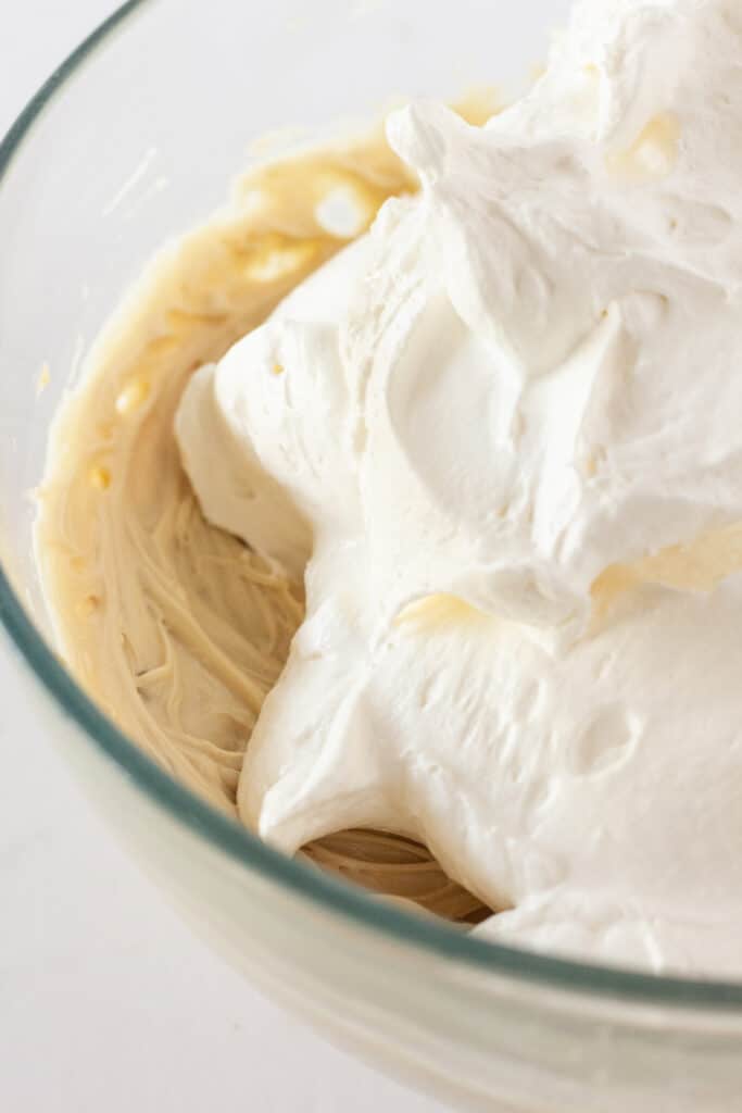 The pecan cream pie filling and whipped topping in a glass mixing bowl.