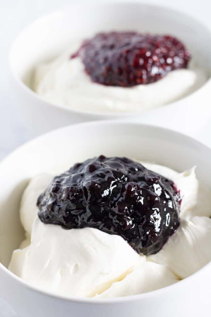 Bowls of vanilla no bake cheesecake filling topped with various jams.