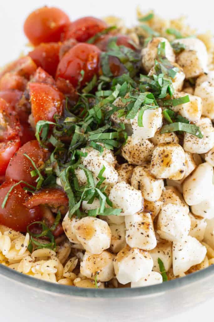 Orzo mozzarella salad topped with a bit more vinaigrette.