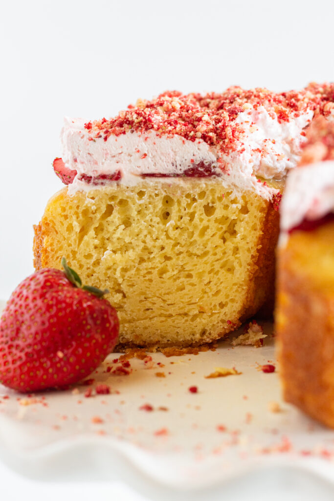 A strawberry crunch pound cake with a slice removed.