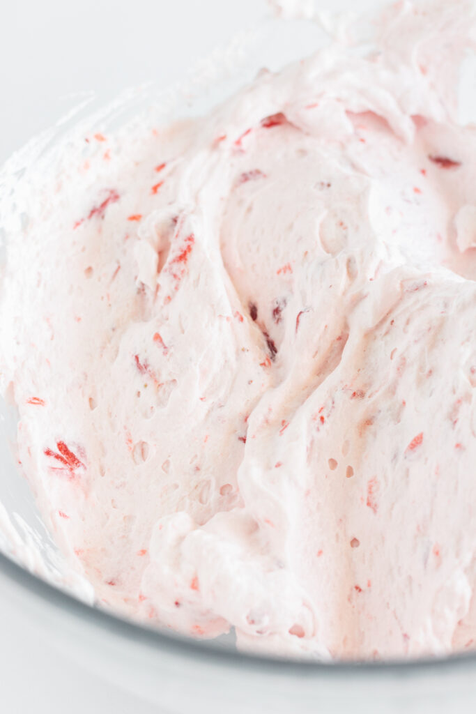 Strawberry whipped cream in a mixing bowl.