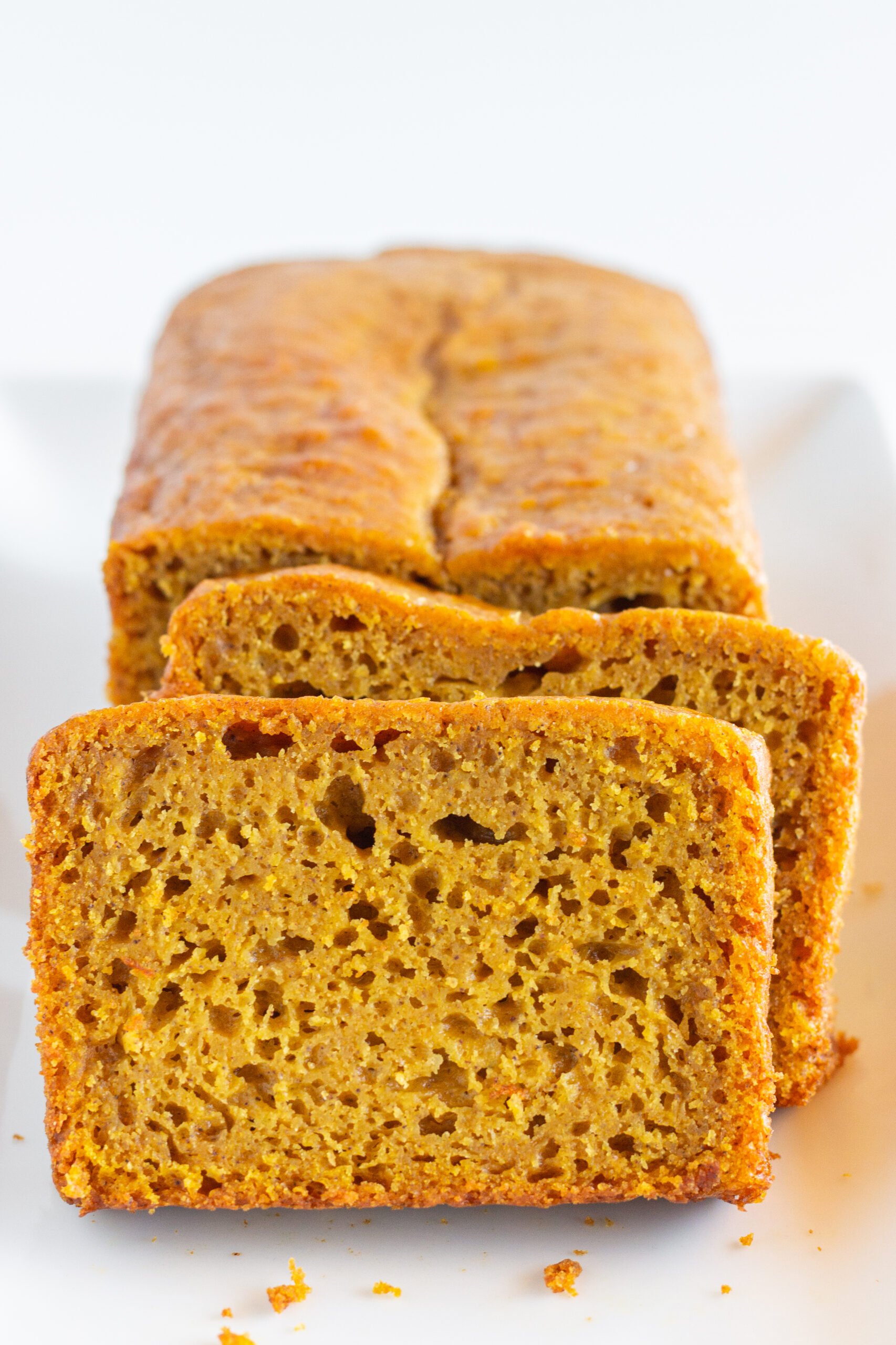 Pumpkin Bread made with a cake mix and sliced on a white plate.