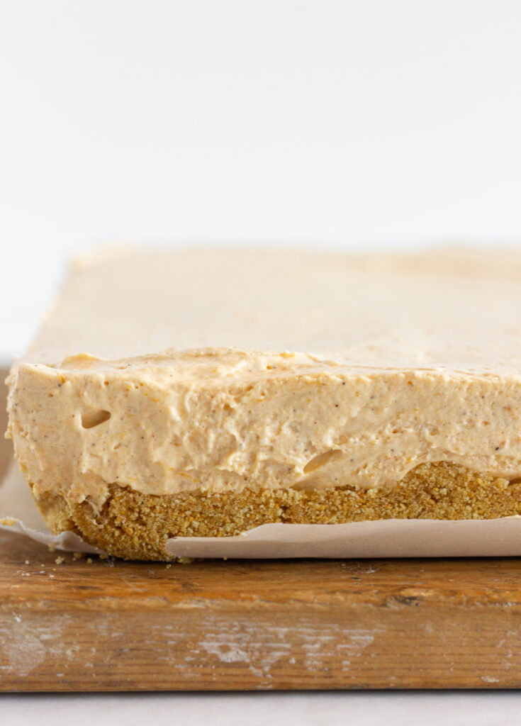 The pumpkin cheesecake bars removed from the baking pan before topping or slicing.