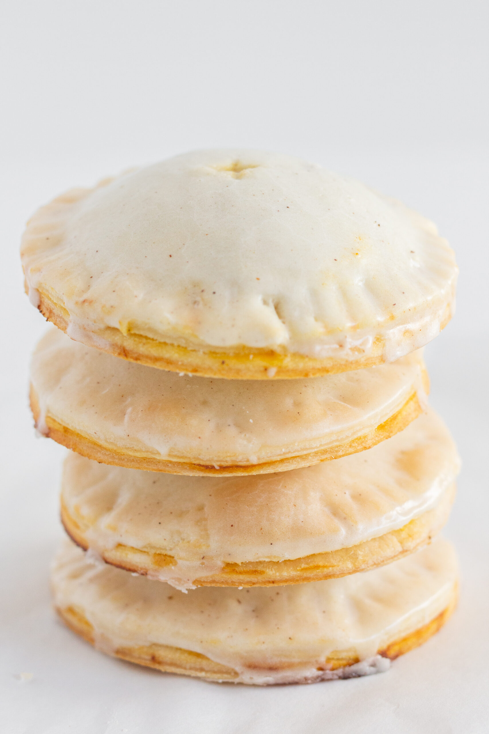 4 pumpkin hand pies stacked on top of each other.