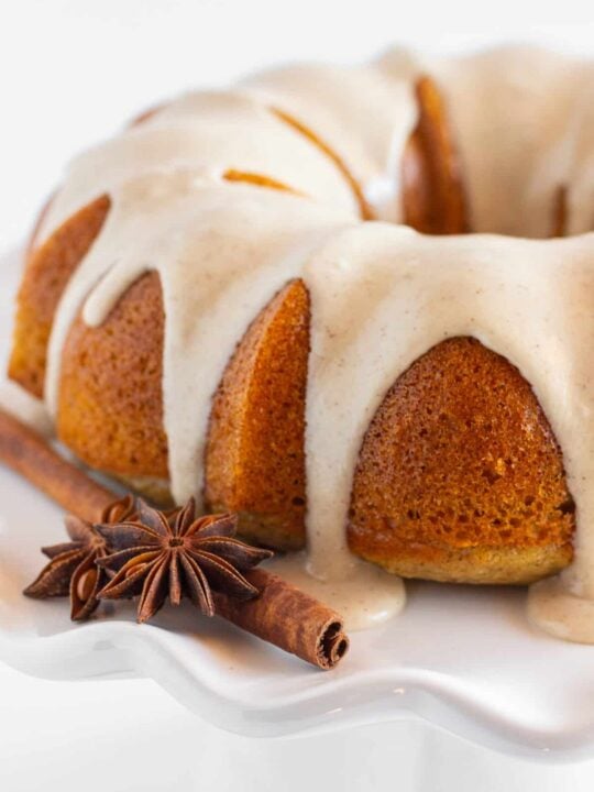 A finished spice bundt cake on a white plate.