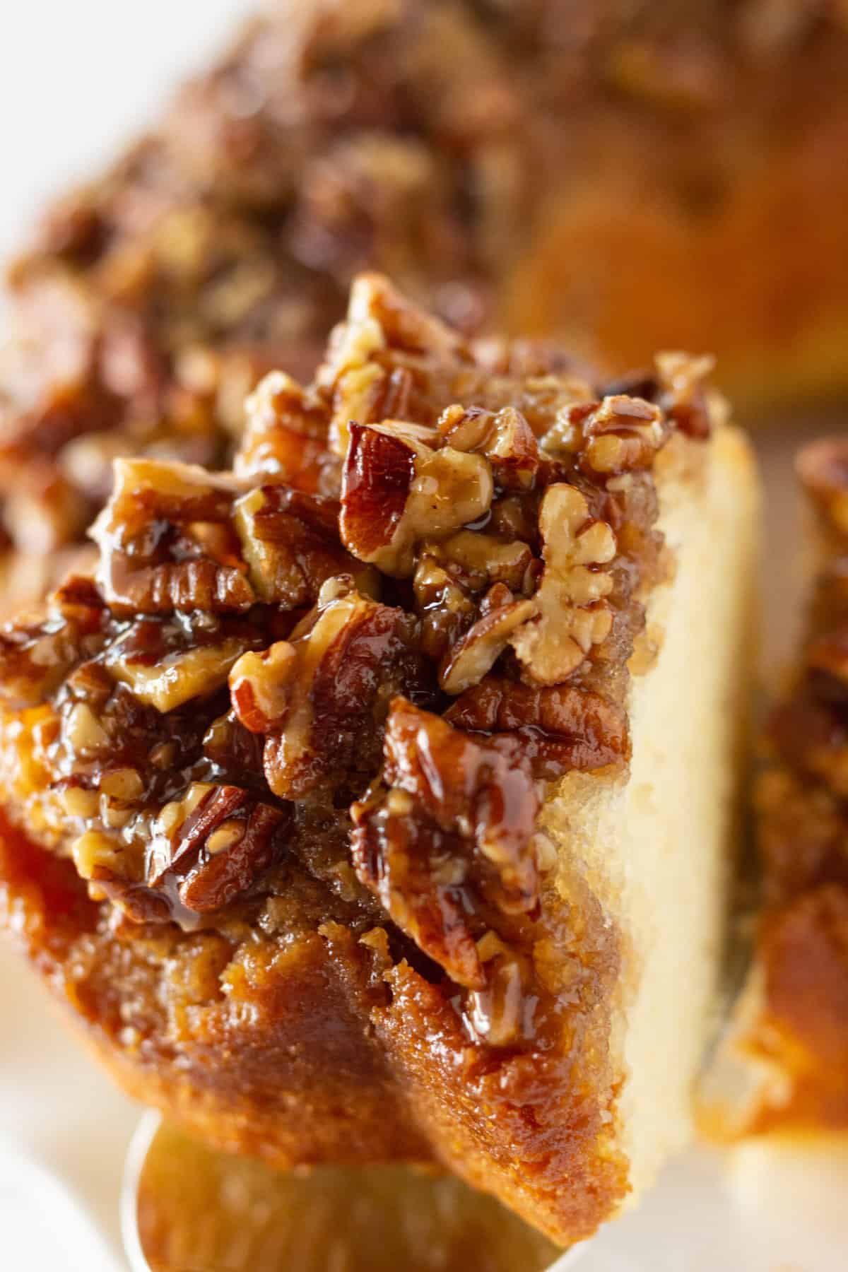 Serving a piece of Pecan Upside Down Bundt Cake.