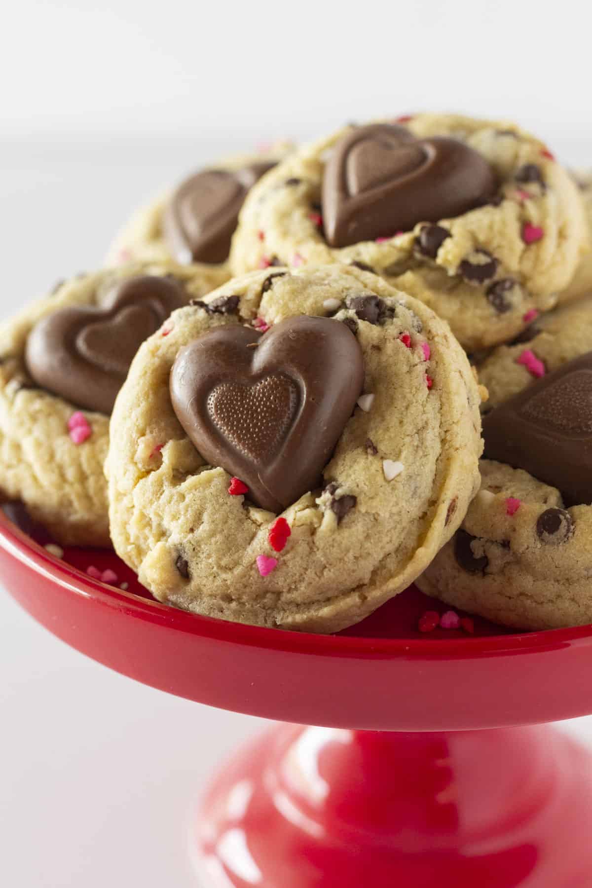 Valentine's Chocolate Chip Cookies on a red cake plate.
