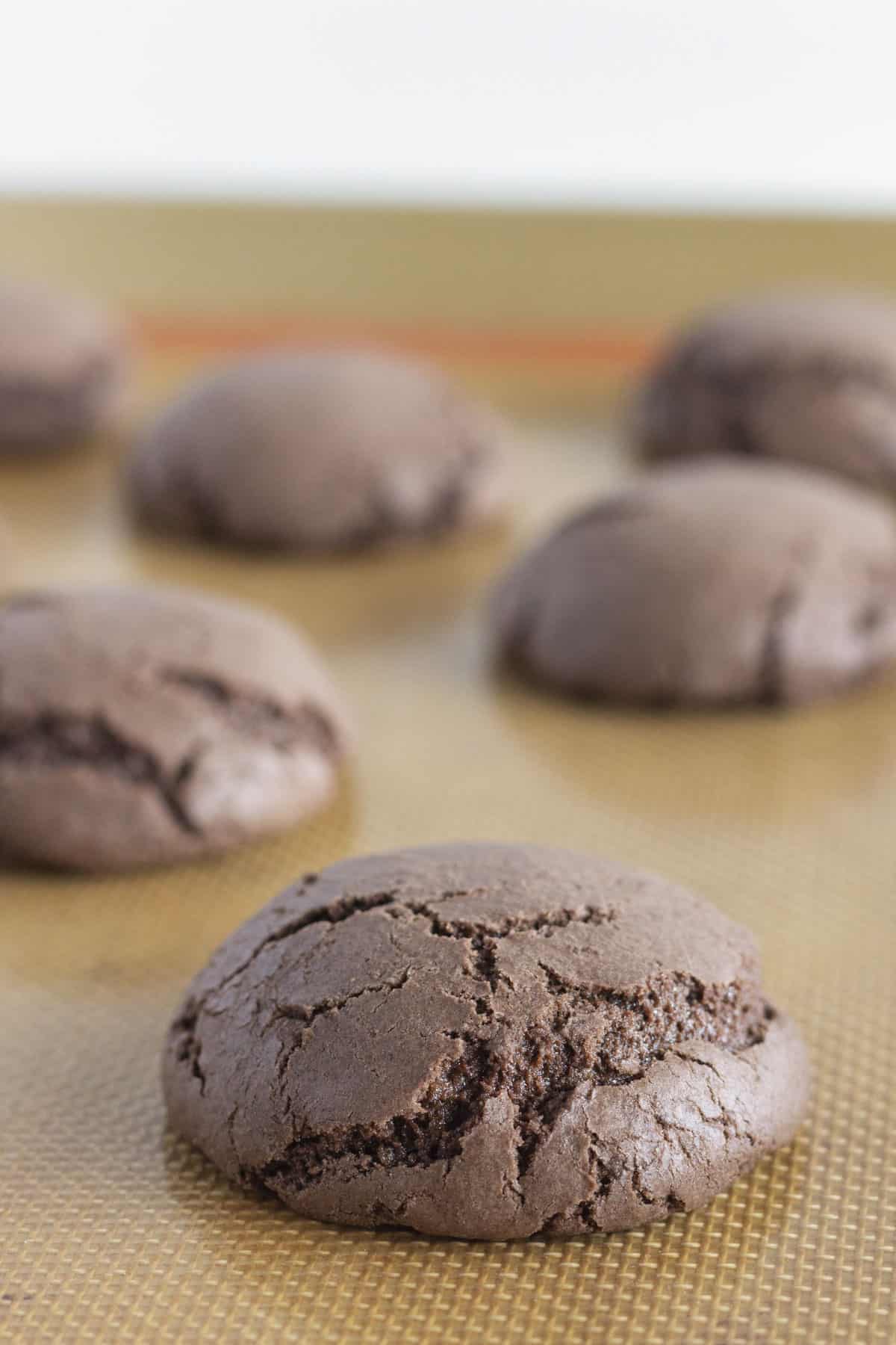 A baking sheet full of chocolate cake mix cookies that are not over baked.