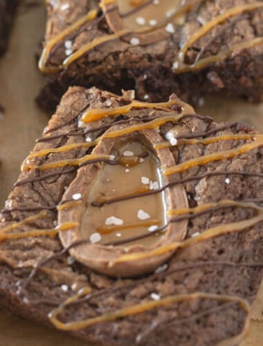 A close up of a chewy brownie with a half of a Cadbury egg baked inside.