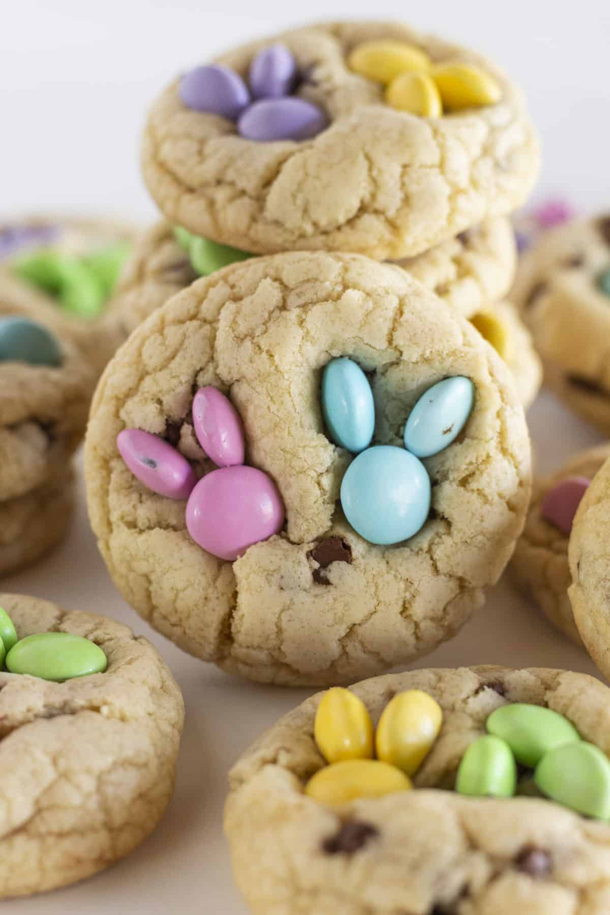 A dozen Easter chocolate chip cookies with spring M&M candies added to look like a a bunny head.