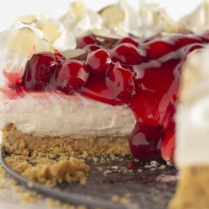 A no bake cherry cheesecake with slices taken out.
