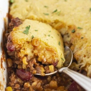 Serving Cowboy Cornbread Casserole with a spoon.
