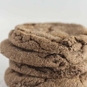 A stack of four Mexican Hot Chocolate Cookies with cinnamon sugar around them.