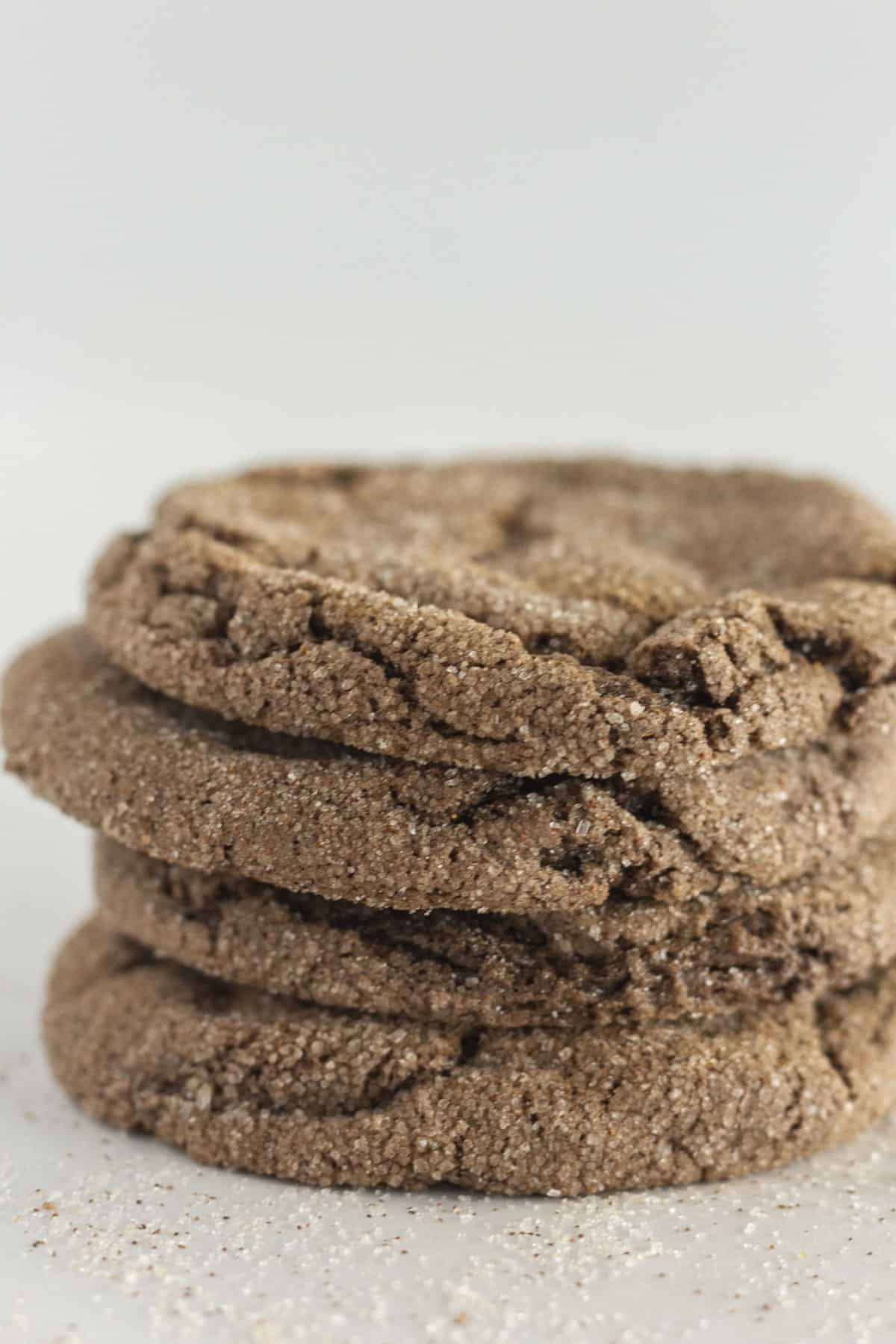 A stack of four Mexican Hot Chocolate Cookies with cinnamon sugar around them.