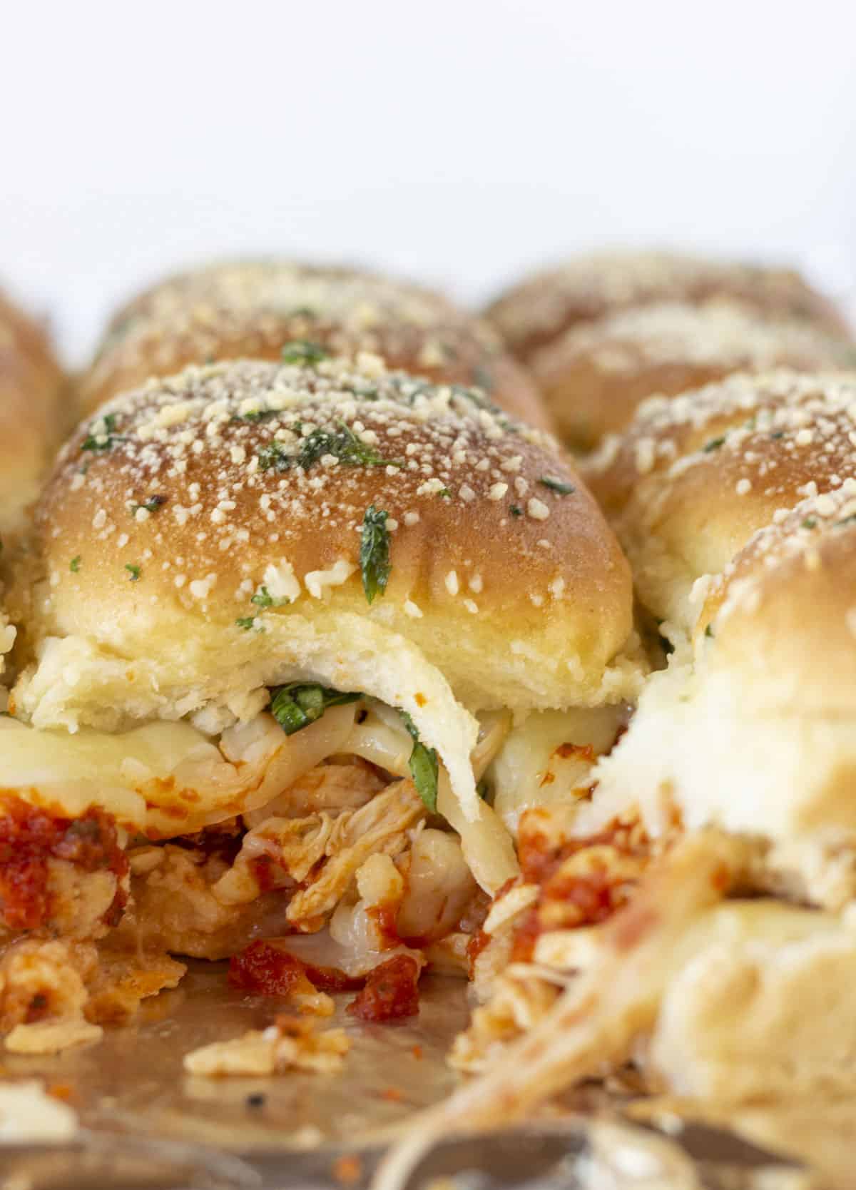 Looking at the inside of baked Chicken Parmesan Sliders.