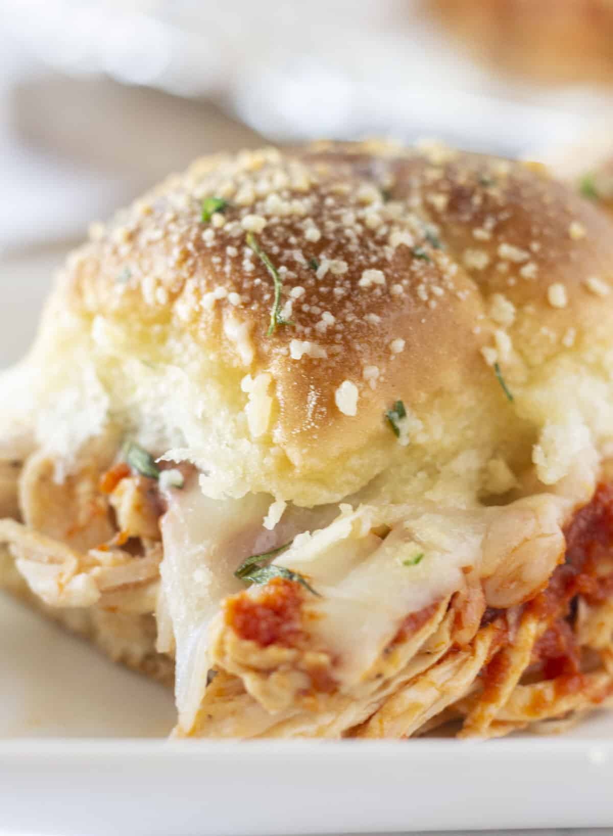 A single chicken parm slider on a plate and ready to serve.