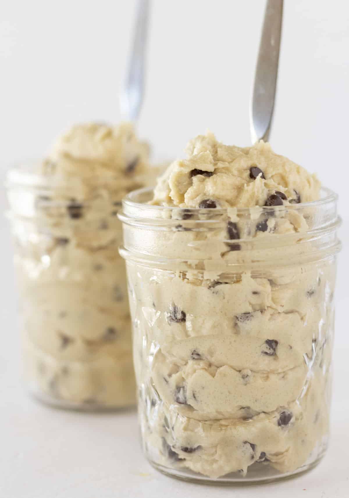 Edible Cookie Dough served in jars with spoons.