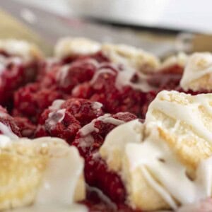 A fresh raspberry galette, sliced and being served.
