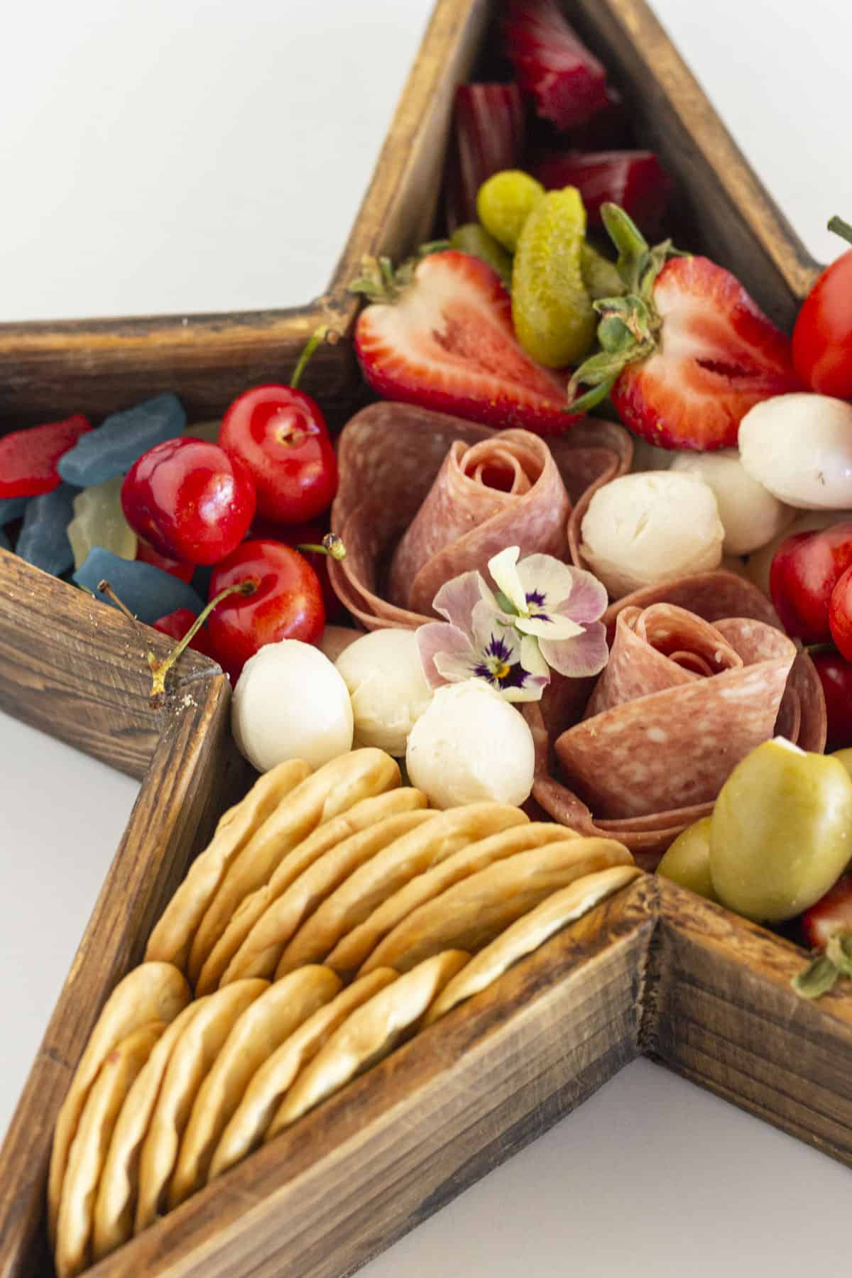 A close up of a star shaped charcuterie board.