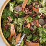 A wooden salad bowl full of broccoli crunch salad.