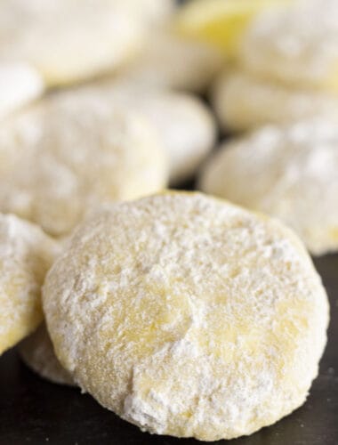 Moist and delicious Lemon Cooler Cookies on a black tray.