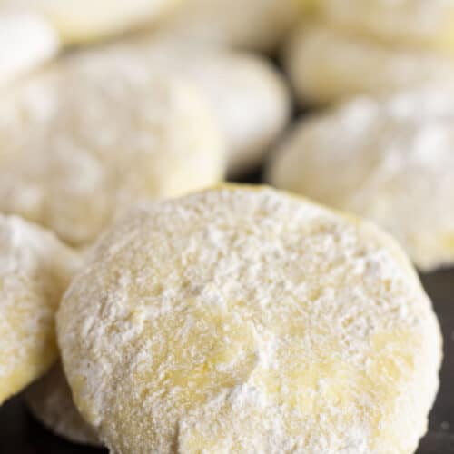 Moist and delicious Lemon Cooler Cookies on a black tray.