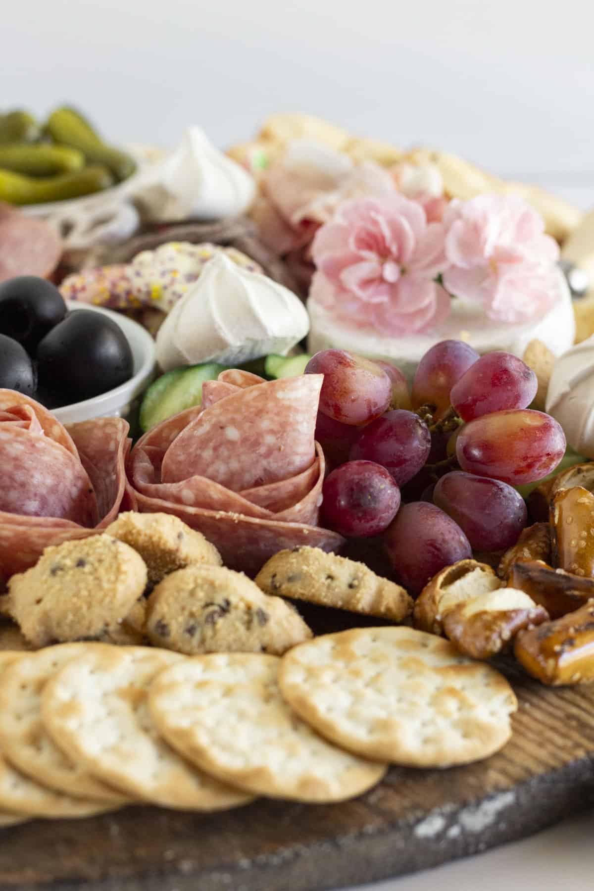 A summer charcuterie board with fresh fruit, cookies and crackers.