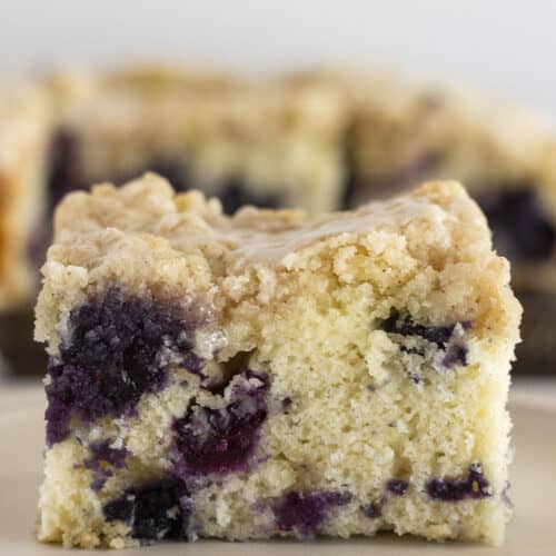 A piece of blueberry muffin cake on a plate and ready to serve.