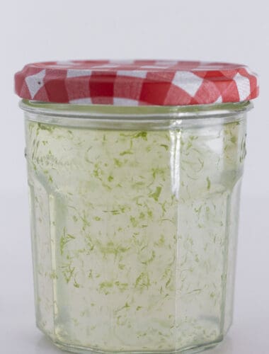 A jar full of lime simple syrup.