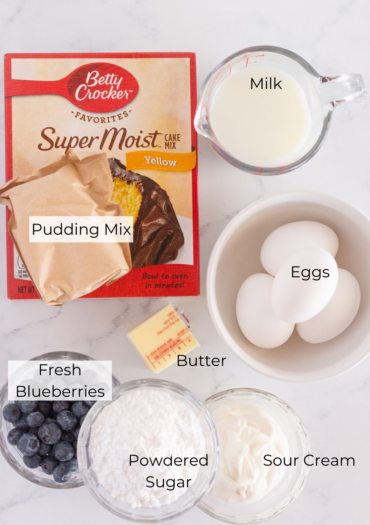 The ingredients needed to make a blueberry bundt cake.