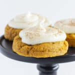 Three Pumpkin Cheesecake Cookies on a black cake plate.