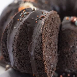 A black velvet cake made with a cake mix with a piece being cut & served.