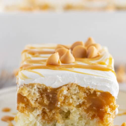 A slice of butterscotch cake on a plate and ready to serve.