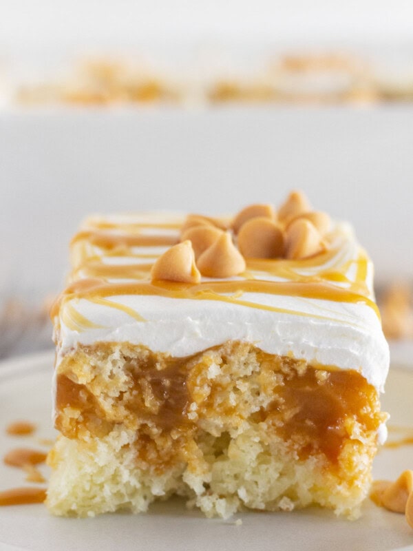 A slice of butterscotch cake on a plate and ready to serve.