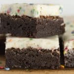 Stacks of birthday brownies cut into squares.