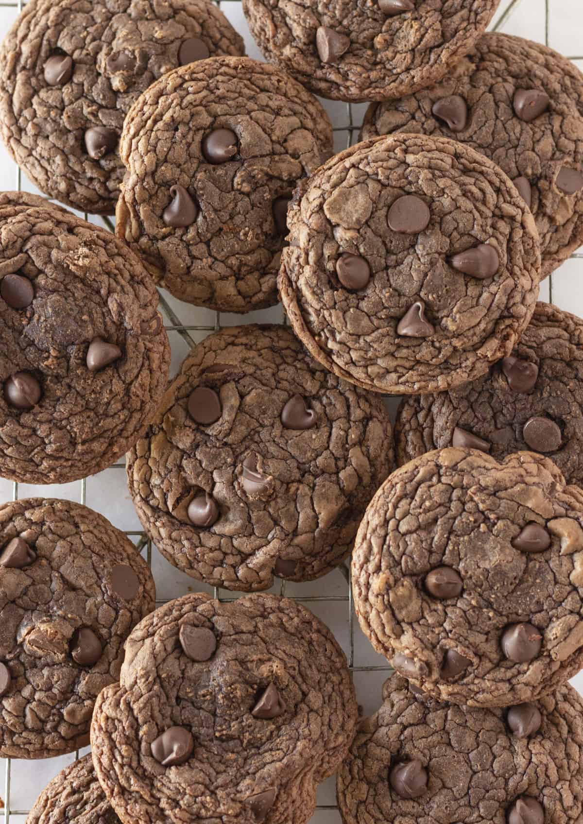 A dozen brownie cookies on a cooling rack.