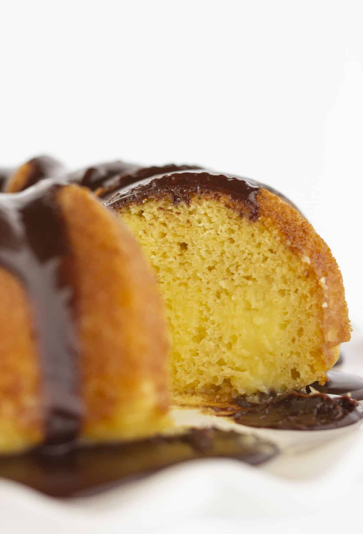 Looking at the inside of a Boston Cream Pie Poke cake with pudding in the middle.