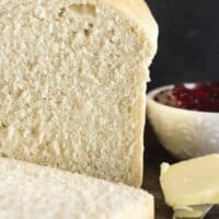 A loaf of one hour bread with butter and jam.