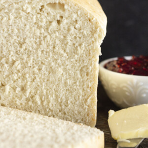 A loaf of one hour bread with butter and jam.