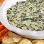 Serving spinach and artichoke dip without mayo and with crackers and carrots.