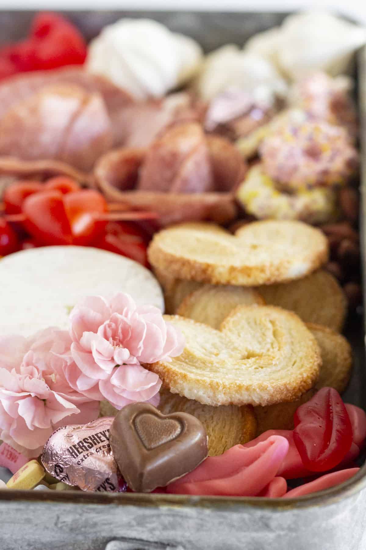 A close up of a Valentine's day Charcuterie Board.