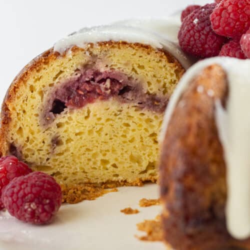 Looking into the inside of a white chocolate and raspberry cake.