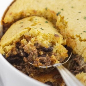 Scooping a serving of Jiffy Tamale Pie.
