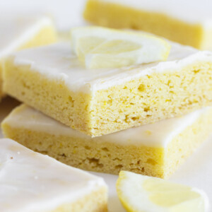 A stack of lemon cake mix cookie bars on a white tray.