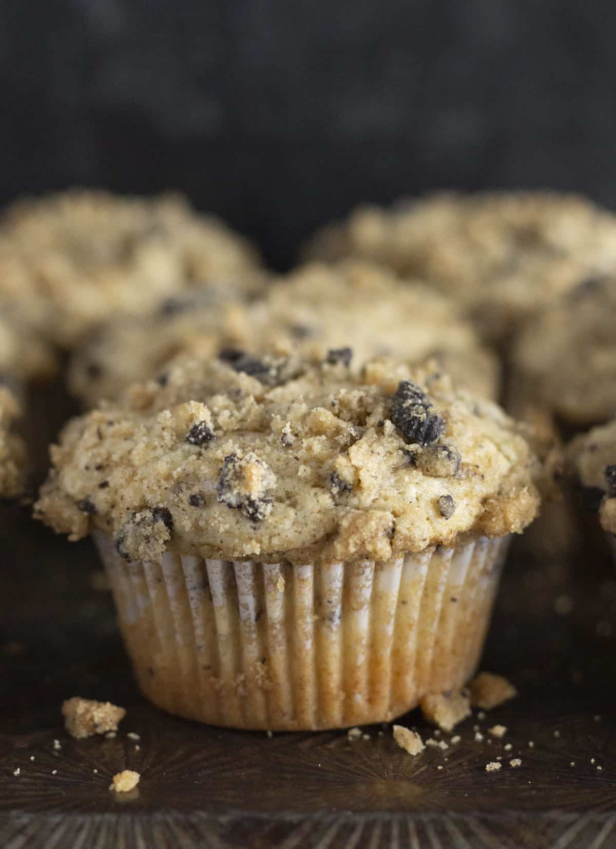Oreo crumb muffins on a black tray.