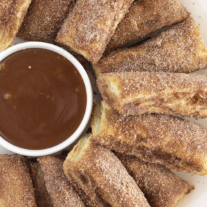 A plate of baked churros, served with salted caramel.