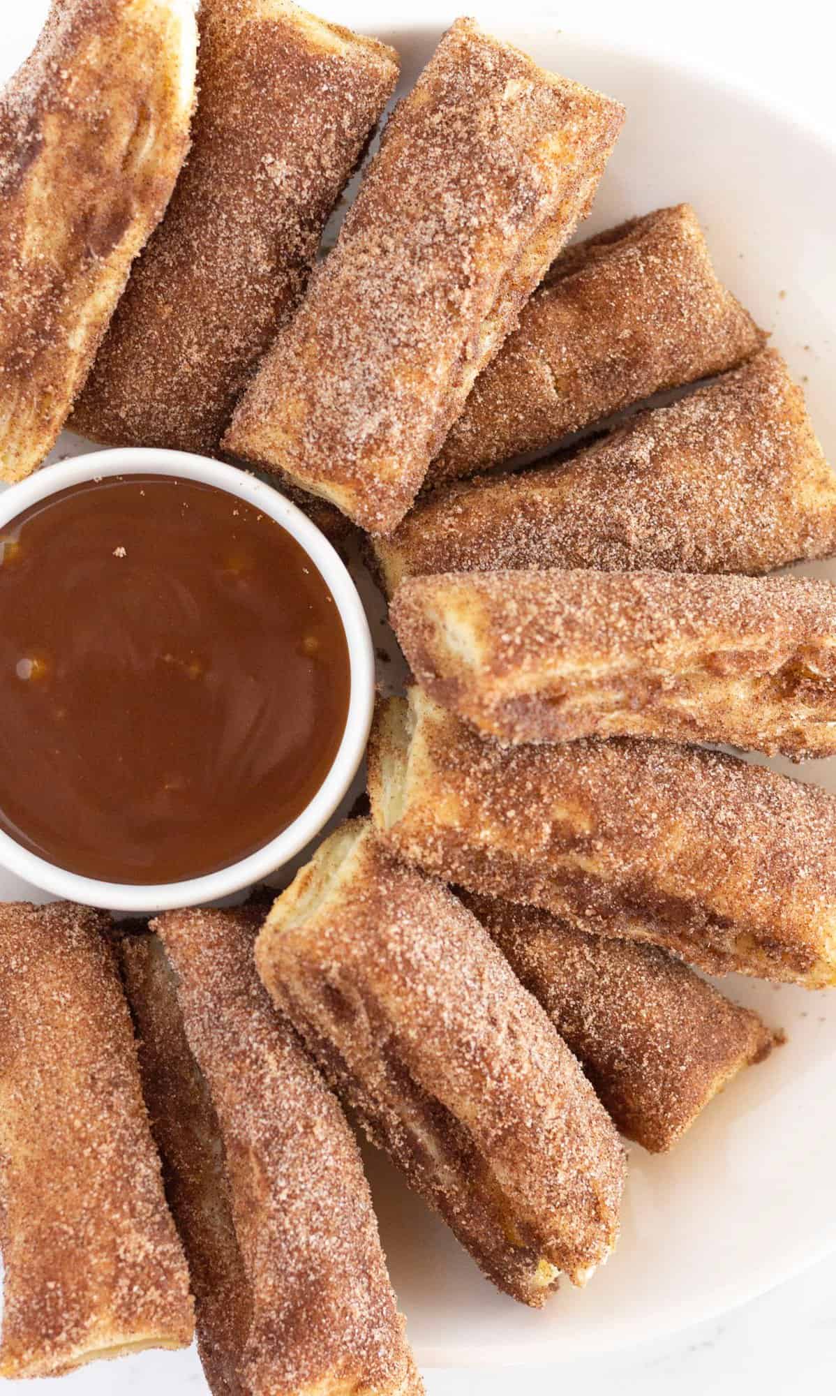 A plate of baked churros, served with salted caramel.