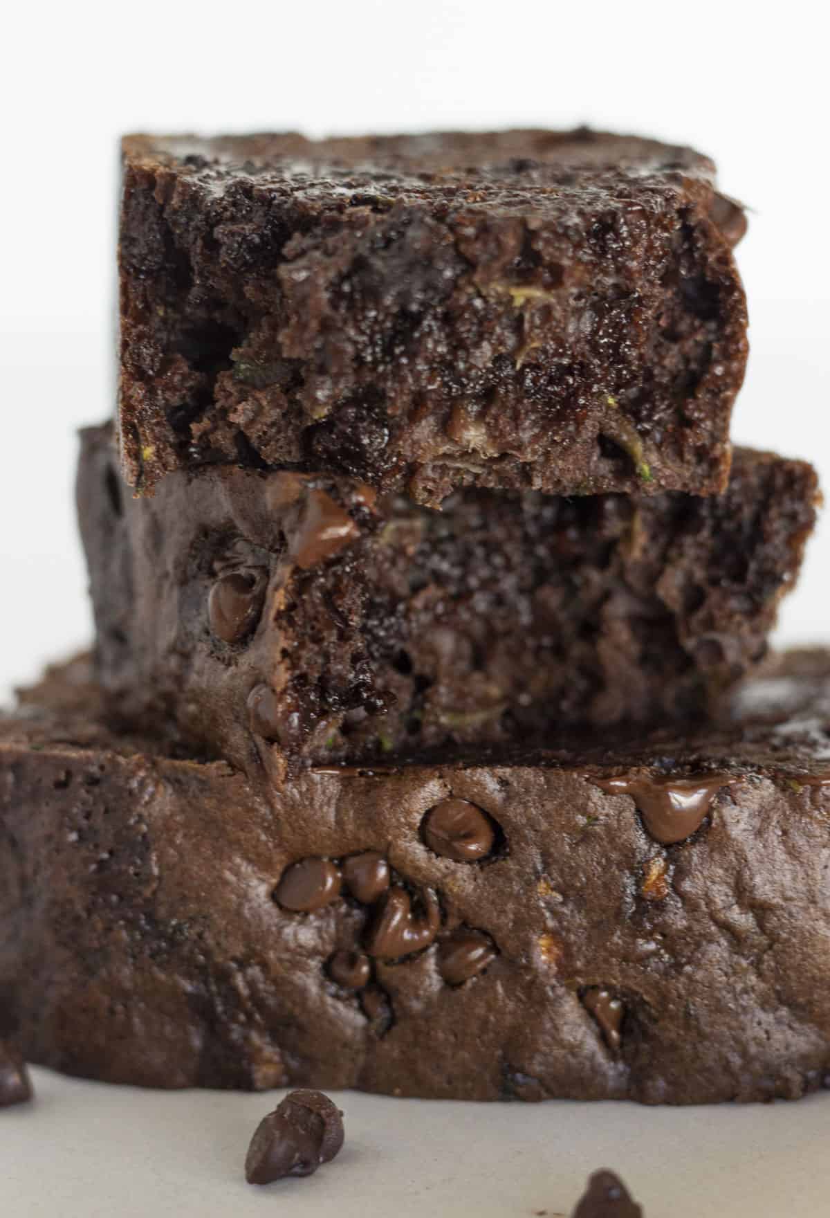 Two pieces of double chocolate zucchini bread stacked on each other.