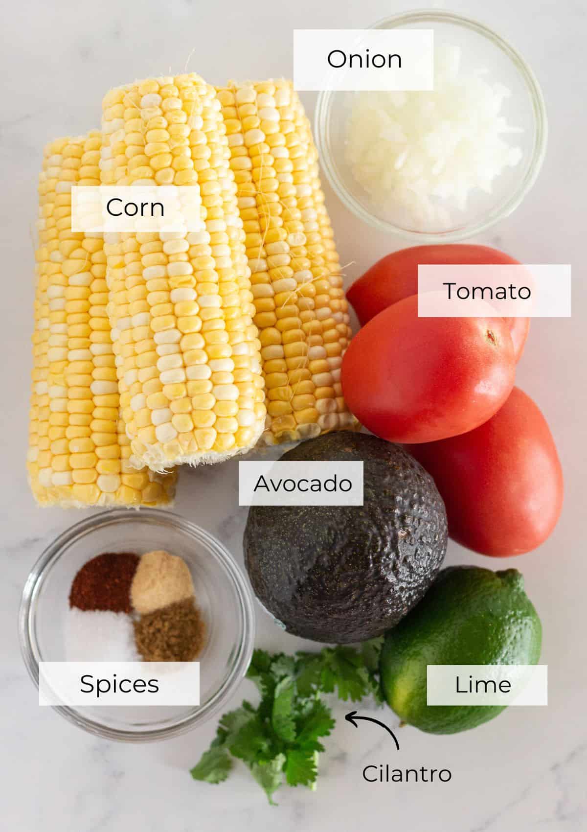 The ingredients needed to make corn and avocado salsa.